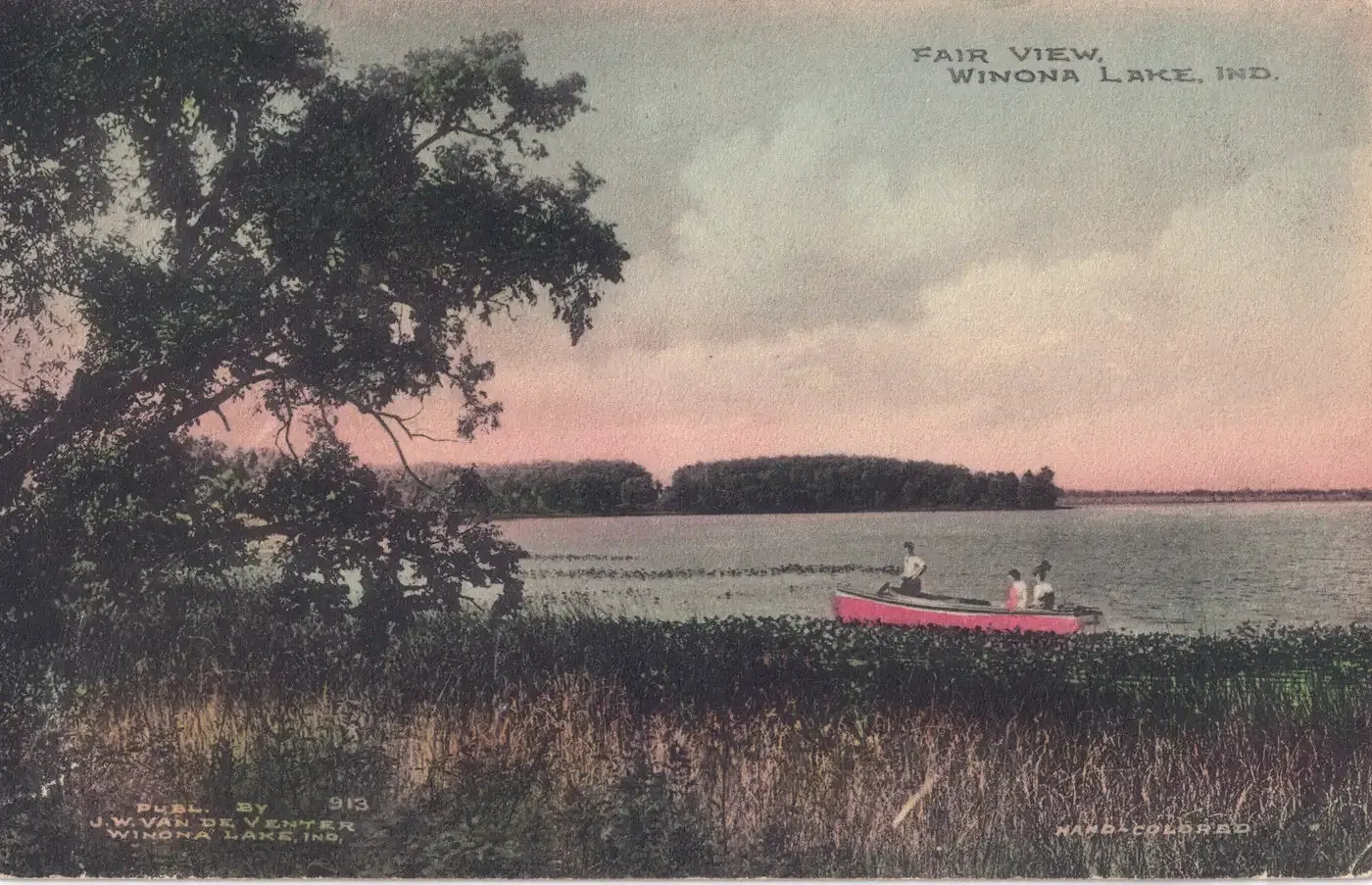 A hand-colored view from a marshy shore across the lake to a wooded far shore under a pink evening sky, with a red canoe carrying two people and a large tree at the left, titled Fair View, Winona Lake, Ind.